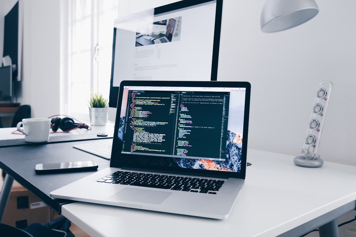 Application code on a laptop in a bright workspace