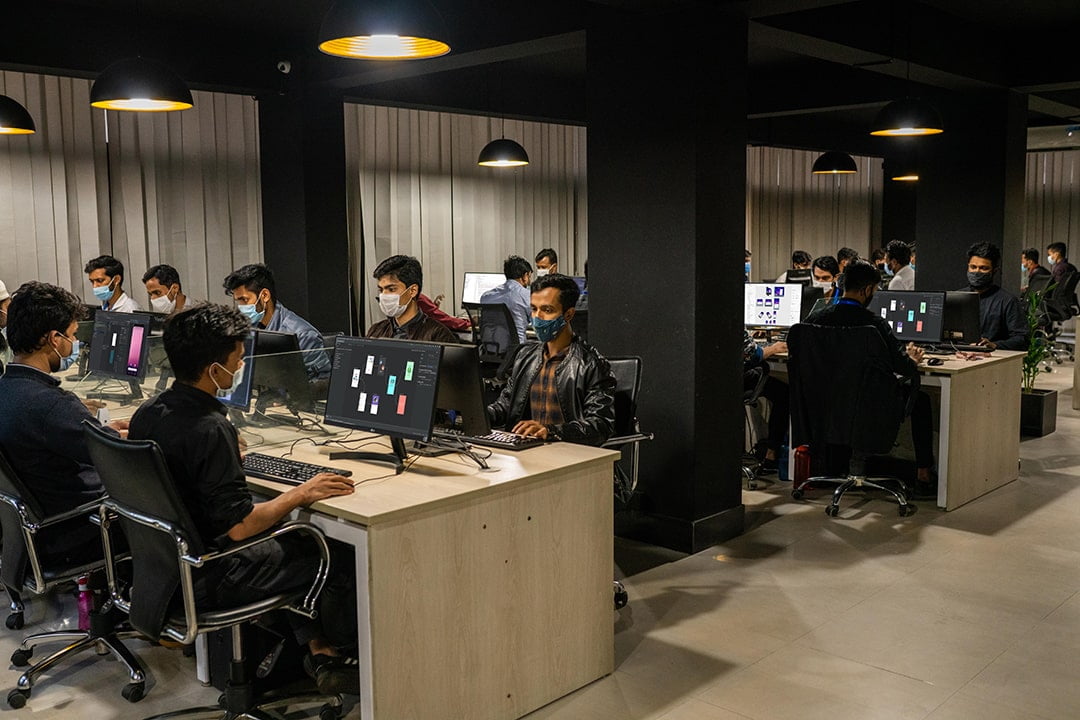 Two Codecony team members collaborating at a desk